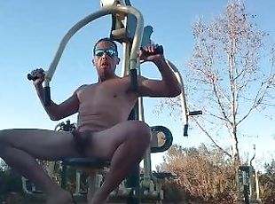 Horny muscle guy works out naked at a park nautilas.   Almost caught by dog walker at the end.