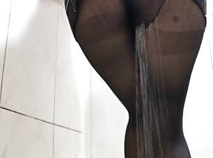 Sexy secretary peeing in her black pantyhose while talking on the phone.